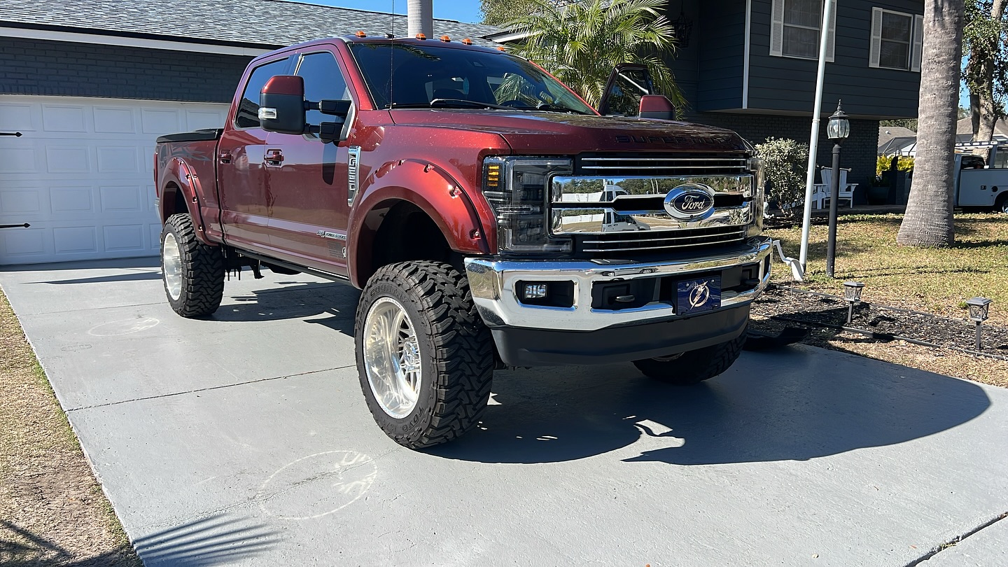 Red Ford truck freshly detailed with polished wheels